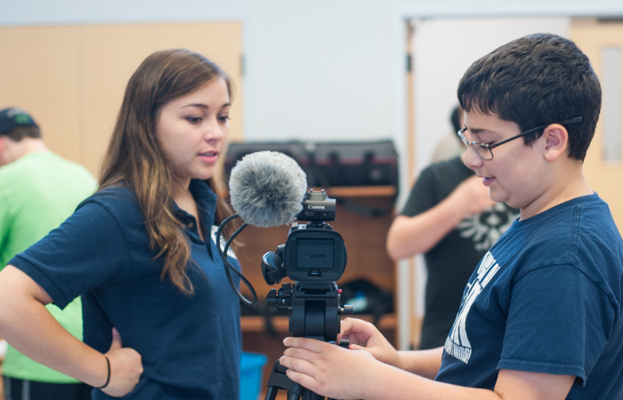 An instructor helps her student prepare for filming.